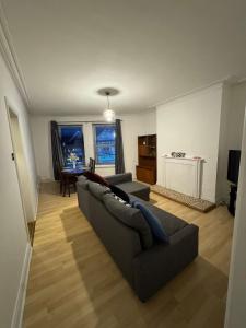 a living room with a couch and a table at Spacious Bournemouth Apartment in Bournemouth