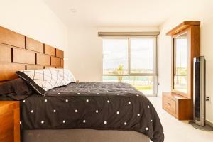 a bedroom with a large bed and a television at Quiet and comfortable space in Aguascalientes