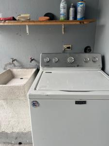 a kitchen with a stove and a white refrigerator at Casa Canaan in Monterrey +11 photos