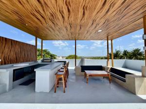 an open kitchen with a large wooden ceiling at Panoramic Ocean Views - Villa Home Chelem in Chelem