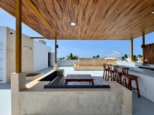 a living area with a table and chairs on a roof at Panoramic Ocean Views - Villa Home Chelem in Chelem