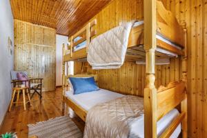 a bedroom with bunk beds in a log cabin at Christys House Skopelos in Glossa