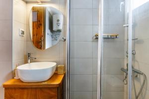a bathroom with a sink and a shower at Christys House Skopelos in Glossa