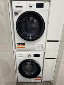 a stack of washing machines and a washer and dryer at CityView Lodge in Chişinău