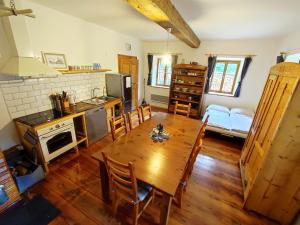 a kitchen and dining room with a wooden table at WildAlps-Apartments in Wildalpen