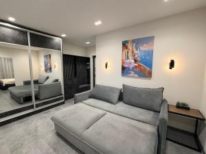 a living room with a couch and a bedroom at CityView Lodge in Chişinău
