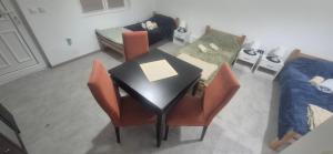 a room with a table and chairs and a bed at Odmorište Noćko in Valjevo +10 photos