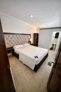 a bedroom with a large bed in a room at Hotel calima royal in Cali