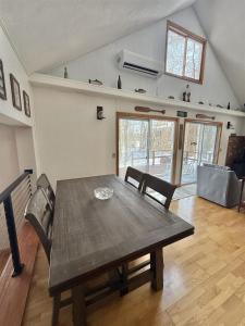 a wooden table and chairs in a living room at UPTA CAMP LIMIT 8 cabin in West Baldwin