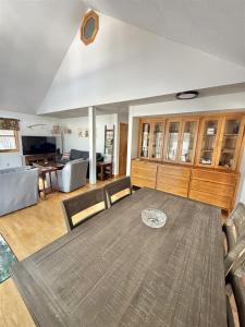 a dining room with a table and a living room at UPTA CAMP LIMIT 8 cabin in West Baldwin