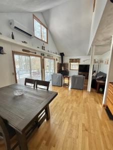 a large living room with a wooden table and chairs at UPTA CAMP LIMIT 8 cabin in West Baldwin +16 photos