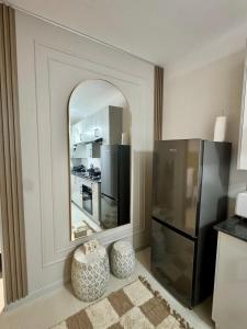 a kitchen with a mirror and a refrigerator at Orchid Belvedere Suites 102 - The Fig in Gaborone