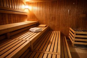 a sauna with two wooden benches in a room at Best Western Faisalabad in Faisalabad