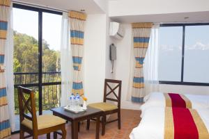Vuode tai vuoteita majoituspaikassa Hotel Himalayan Villa