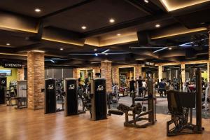 a gym with rows of treadmills and machines at Best Western Faisalabad in Faisalabad