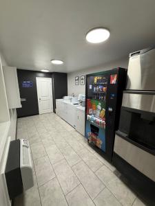 a large kitchen with a refrigerator and a counter at Americas Best Value Inn Ponca City in Ponca City
