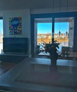 a living room with a fireplace and a large window at Traum - Apartment mit Spa im Haus in Dortmund