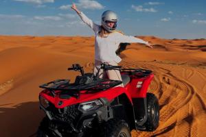 a person on a atv in the desert at Nomads Trails Camp in Merzouga