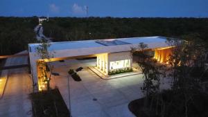 a modern house with lights on the roof at Casa Edén in Xpu Ha