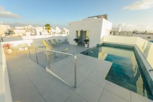 a balcony with a swimming pool on top of a building at Apartamentos Aires de Conil in Conil de la Frontera