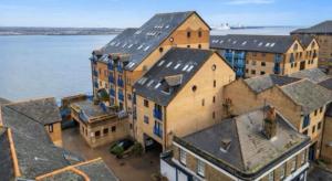 an aerial view of a large building next to the water at Thames Riverside Studio, Gravesend Town Centre - near train station in Gravesend
