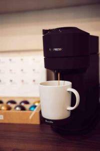 a coffee maker is making a cup of coffee at Redwood Place in Fort Saint John