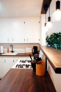 a kitchen with a counter and a stove top oven at Redwood Place in Fort Saint John