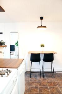 a kitchen with a table and two chairs at Redwood Place in Fort Saint John