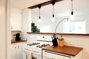 a kitchen with a white stove and some lights at Redwood Place in Fort Saint John