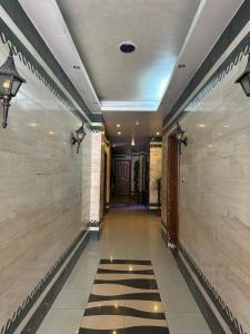 a hallway of a building with a tile floor at Al Majd Hotel in Amman