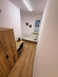a hallway with a room with a desk and a bed at Zamkowy Hostel Gdansk Old Town in Gdańsk