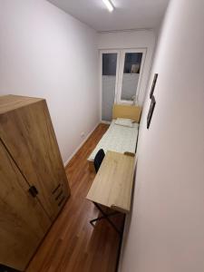 a small room with a desk and a room with a window at Zamkowy Hostel Gdansk Old Town in Gdańsk +2 photos
