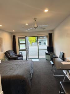 a hotel room with a bed and a living room at A'La Vista Motel in Palmerston North +18 photos