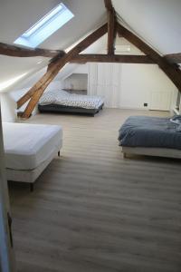 a attic bedroom with two beds and a skylight at Escale à Rosay in Theuville