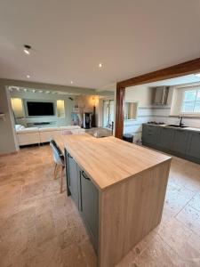 a large kitchen with a large island in the middle at Escale à Rosay in Theuville +26 photos