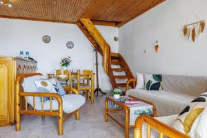 a living room with wooden furniture and a staircase at Christys House Skopelos in Glossa