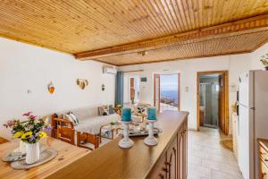 a kitchen with a table and a living room at Christys House Skopelos in Glossa +41 photos