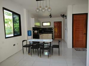 a kitchen and dining room with a table and chairs at Seanna's Inn in San Juan +3 photos
