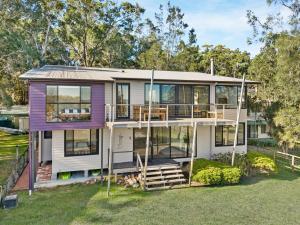 an image of a house with large windows at Pindimar Beach Sanctuary Absolute Beachfront in Pindimar