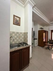 a kitchen with a sink and a counter top at Al Majd Hotel in Amman