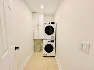a laundry room with a washer and dryer at Bright & Cozy Home in Niagara Falls with Free Parking in Niagara Falls