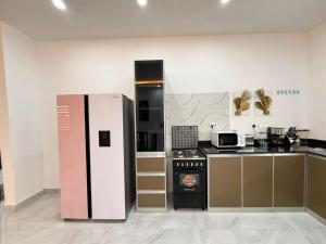 a kitchen with a refrigerator and a stove at Samash villa foxdale 2 bedroom in Lusaka