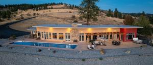 a house with a swimming pool in front of it at Alpine Luxury Chelan Vacation Rentals in Chelan