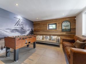 a living room with a pool table and a couch at Mozart Lodge in Wagrain