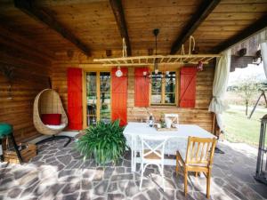 a patio with a white table and chairs in a house at Feistritz Berg und See in Feistritz ob Bleiburg