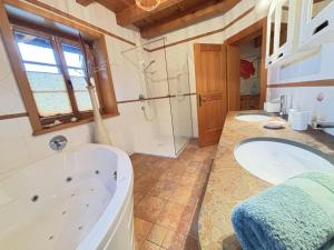 a bathroom with two sinks and a bath tub at Feistritz Berg und See in Feistritz ob Bleiburg +17 photos