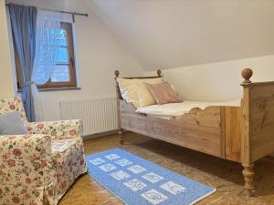a bedroom with a bed and a chair at Feistritz Berg und See in Feistritz ob Bleiburg