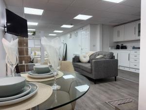 a living room with a glass table and a couch at The Shepherd in Hunslet
