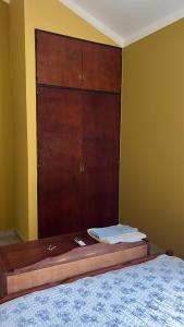 a bed with a wooden dresser in a bedroom at Tu departamento en Formosa in Formosa