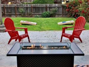two red chairs and a fire pit in a yard at Charming Craftsman - Beach Close in Long Beach